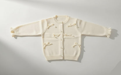 كارديجان للأطفال – سترة صوفية ناعمة بفيونكات ولون كريمي